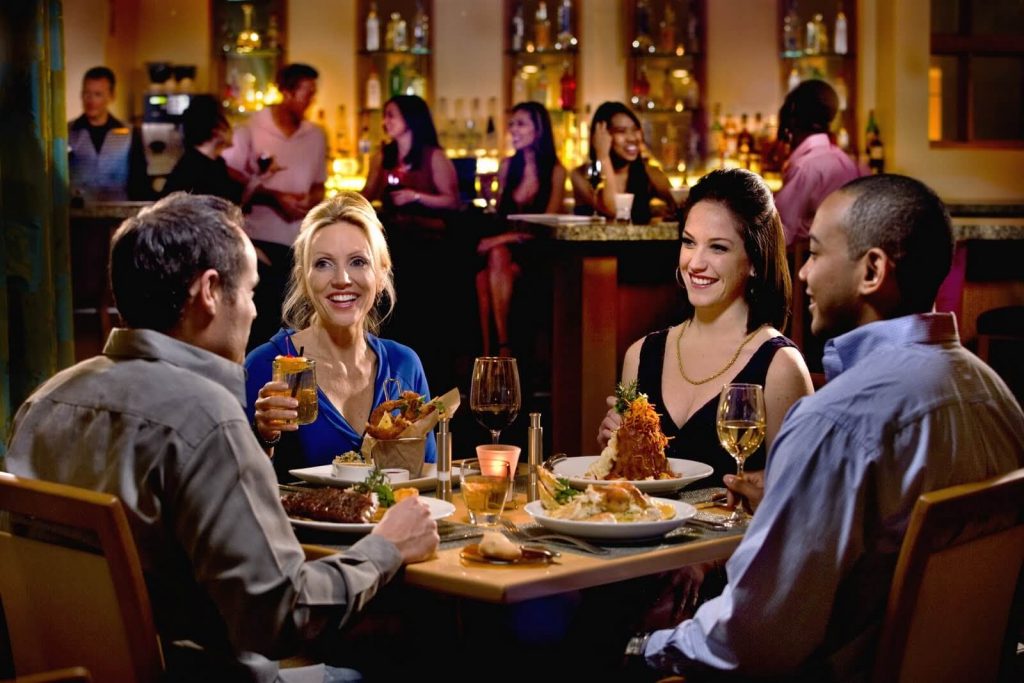 Photo showing a group of people enjoying a meal together at a restaurant.
