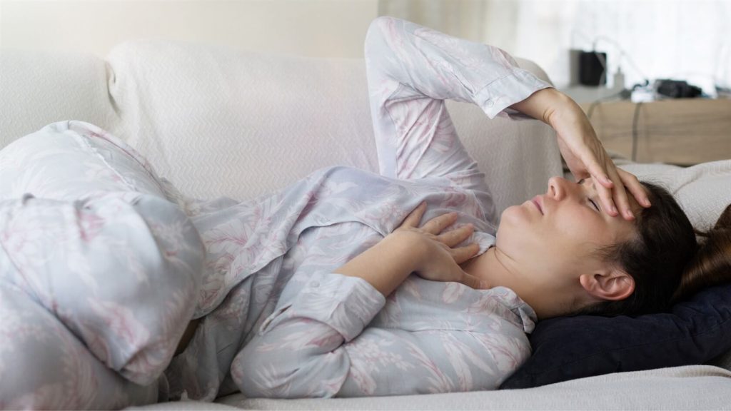 Photo of a bed-ridden woman looking ill